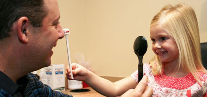 Doctor inspecting childs eyes image